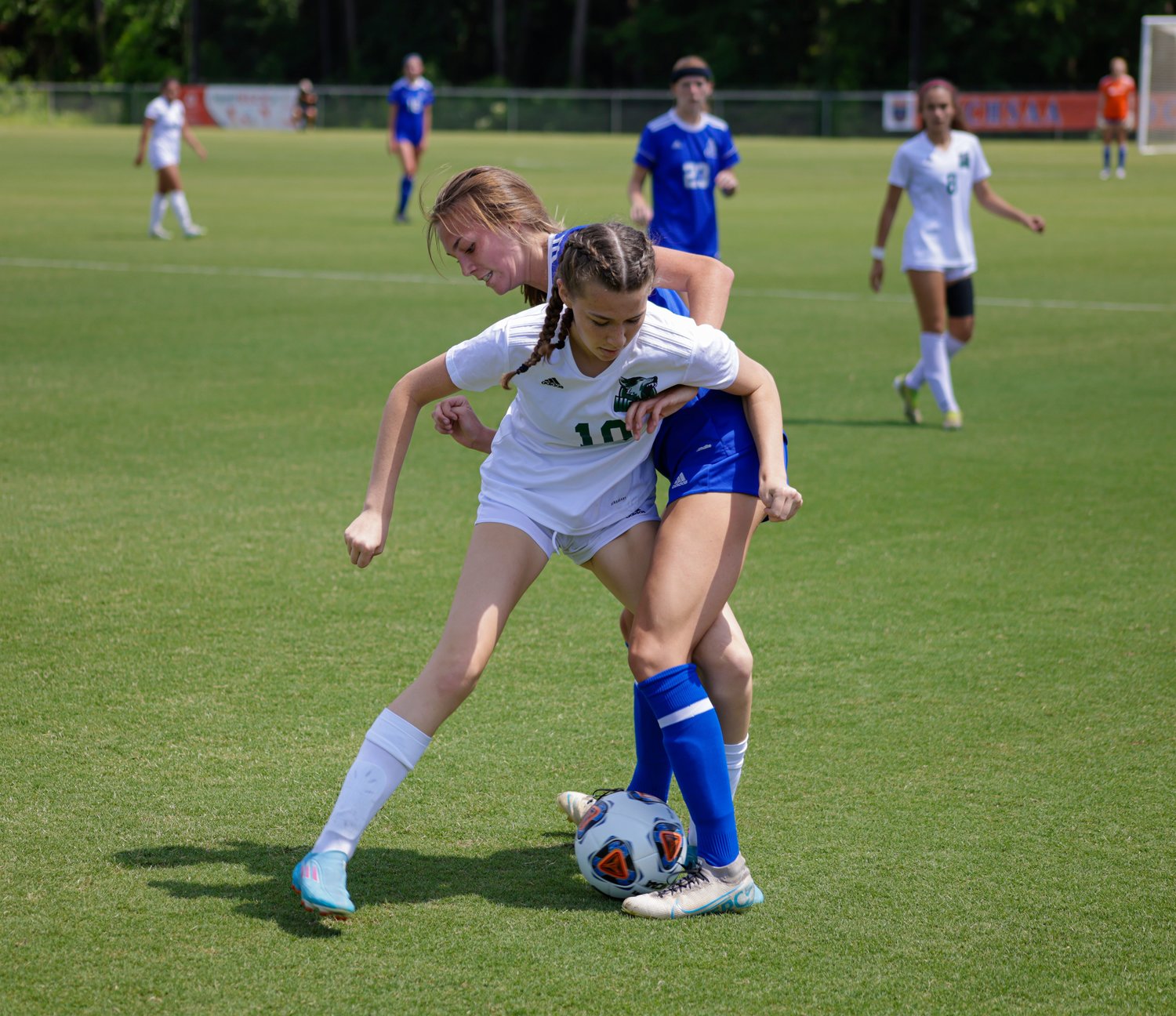 Woods Charter sophomore Cate Czyzewski (10) fights for possession of the ball with a Christ the King defender during the Wolves' 3-0 loss to the Crusaders in the 1A state title game last Saturday in Cary.